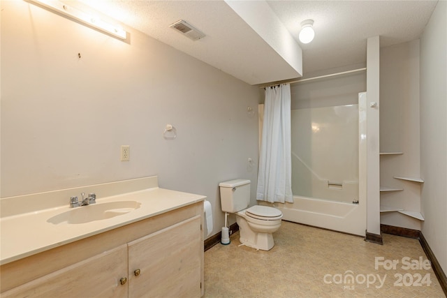 full bathroom featuring vanity, toilet, a textured ceiling, and shower / tub combo