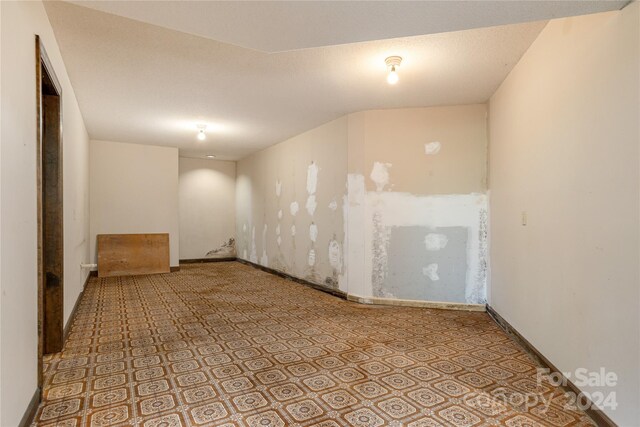 spare room with a textured ceiling