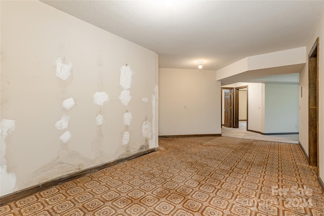 unfurnished room featuring a textured ceiling