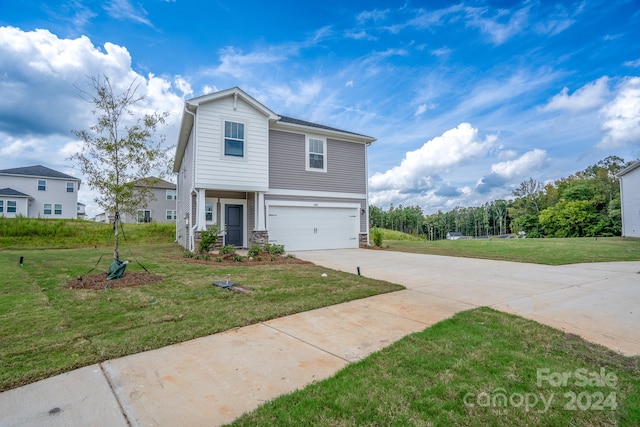 view of front of property featuring a front lawn and a garage