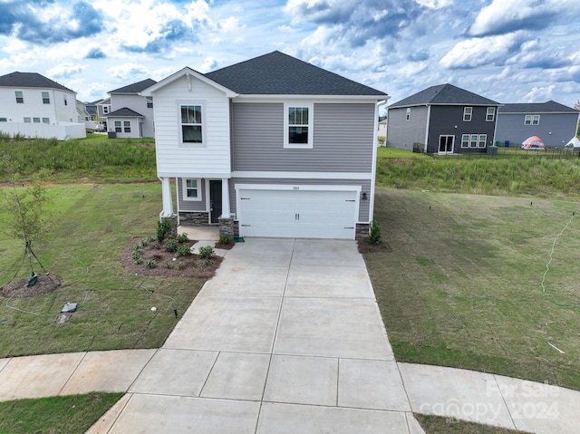 view of front of house with a front yard and a garage