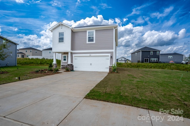 view of front facade with a front yard and a garage