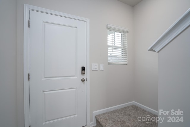 doorway with carpet flooring