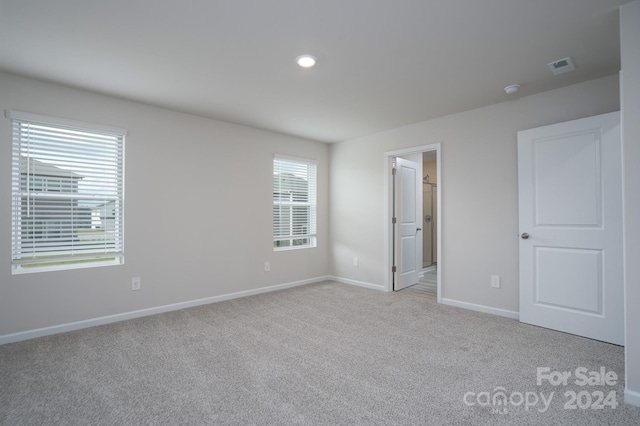 unfurnished bedroom featuring light colored carpet