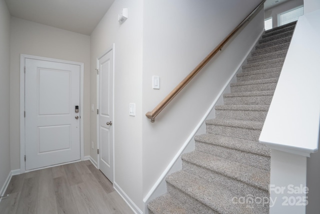 stairs with hardwood / wood-style flooring