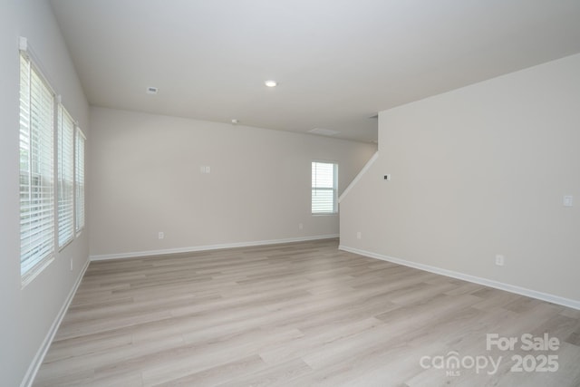 spare room featuring light wood-type flooring