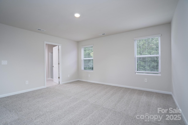 empty room featuring light colored carpet