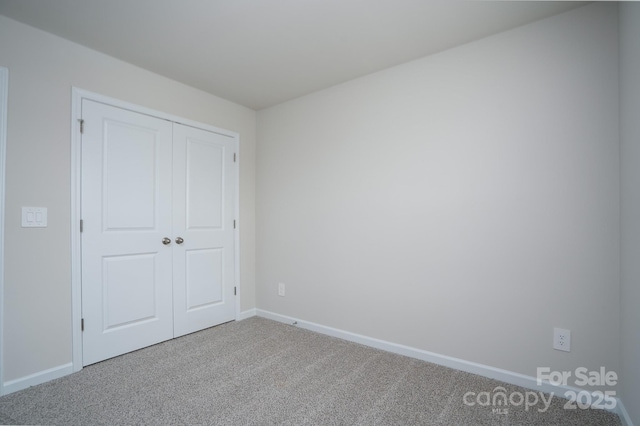 unfurnished bedroom with a closet and carpet