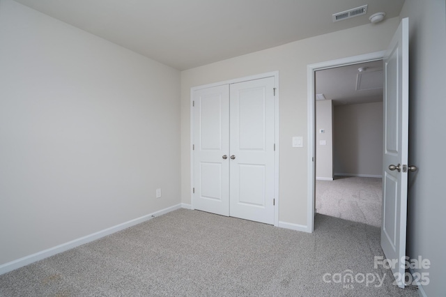 unfurnished bedroom with carpet floors and a closet