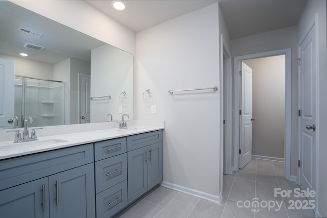 bathroom with walk in shower, tile patterned floors, and vanity