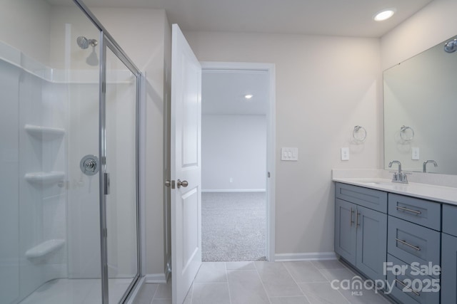 bathroom with tile patterned floors, vanity, and a shower with shower door