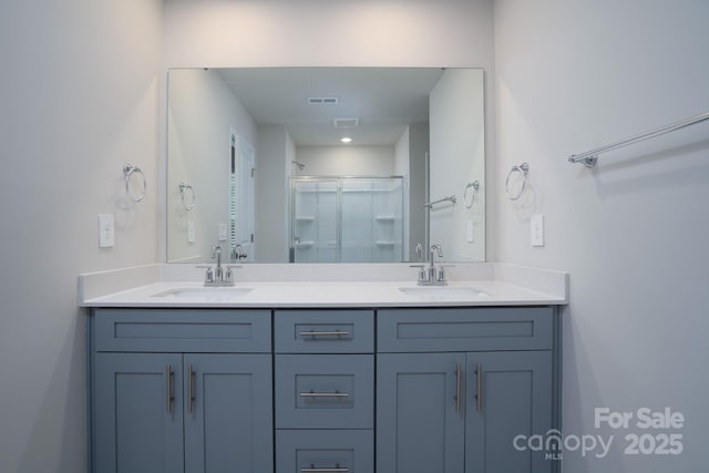 bathroom with vanity and a shower with shower door