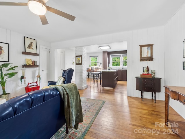 living room with ceiling fan and hardwood / wood-style floors