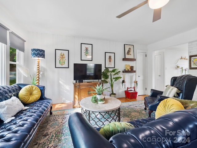 living room featuring hardwood / wood-style floors and ceiling fan