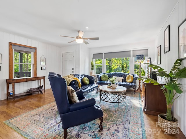 living room with wood-type flooring and ceiling fan