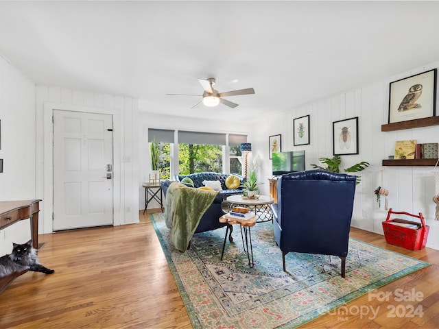 living room featuring ceiling fan and light hardwood / wood-style flooring