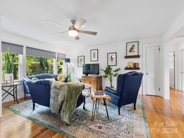 living room with light wood-type flooring and ceiling fan