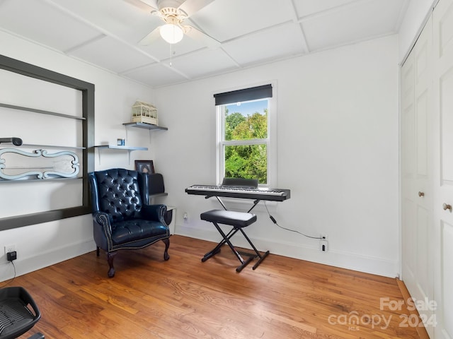 living area with hardwood / wood-style flooring and ceiling fan