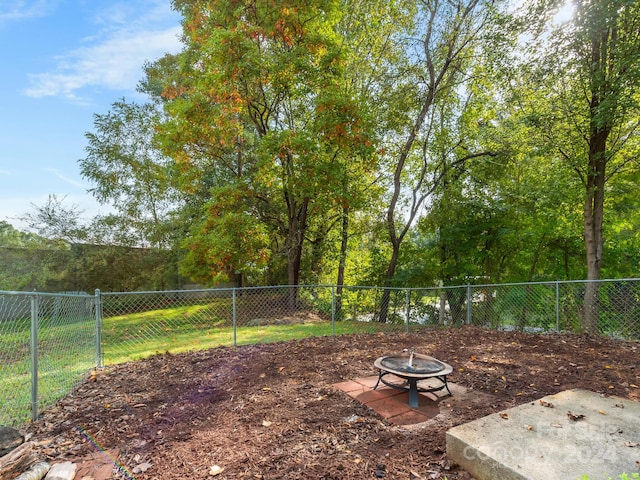 view of yard with a fire pit