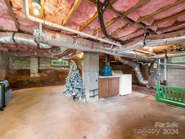 basement featuring washer / clothes dryer and heating unit