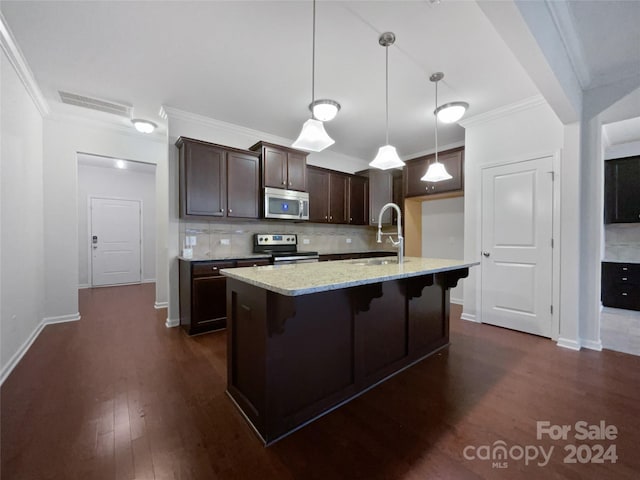 kitchen with appliances with stainless steel finishes, hanging light fixtures, light stone counters, dark hardwood / wood-style flooring, and sink