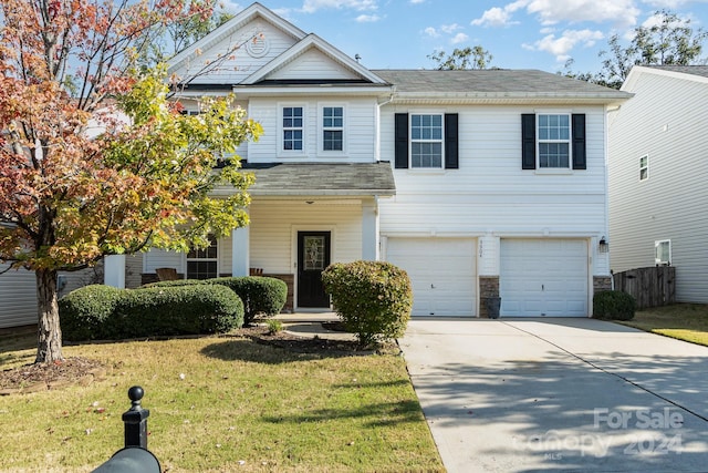 view of front of home featuring a garage and a front lawn