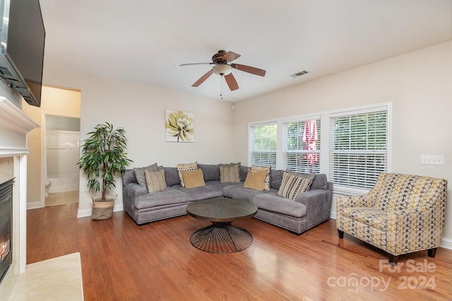 living room featuring wood-type flooring and ceiling fan