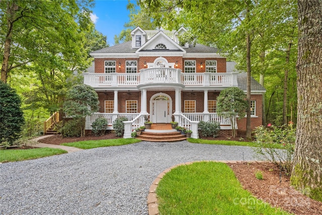 10250 Barringer Ct, Mount Pleasant, NC 28124 - view of front facade featuring brick siding, a porch, driveway, and a balcony
