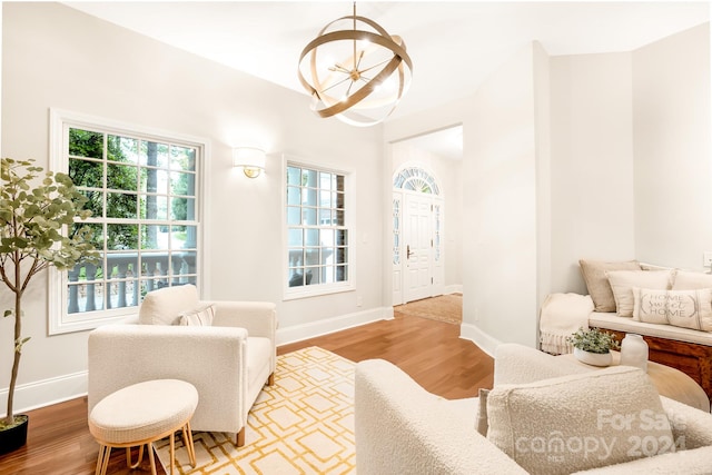 living room with an inviting chandelier and hardwood / wood-style floors