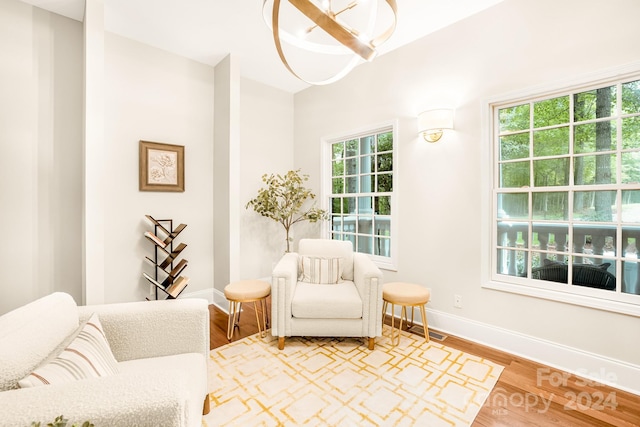 10250 Barringer Ct, Mount Pleasant, NC 28124 - living area featuring baseboards, visible vents, light wood-style flooring, and an inviting chandelier