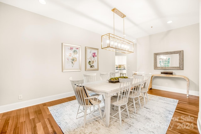 dining area featuring a notable chandelier and light hardwood / wood-style floors