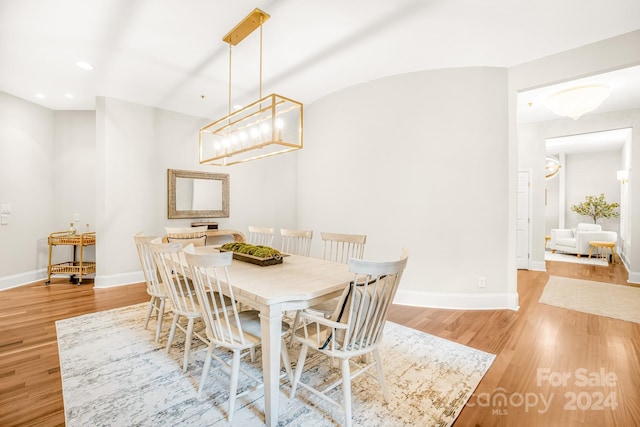 dining space with a notable chandelier and light wood-type flooring