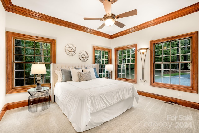 carpeted bedroom featuring ceiling fan and crown molding