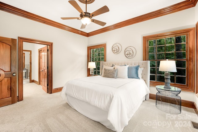 carpeted bedroom featuring ceiling fan and ornamental molding