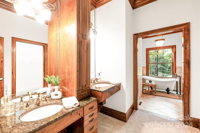 bathroom featuring a bath, crown molding, tile patterned flooring, and vanity