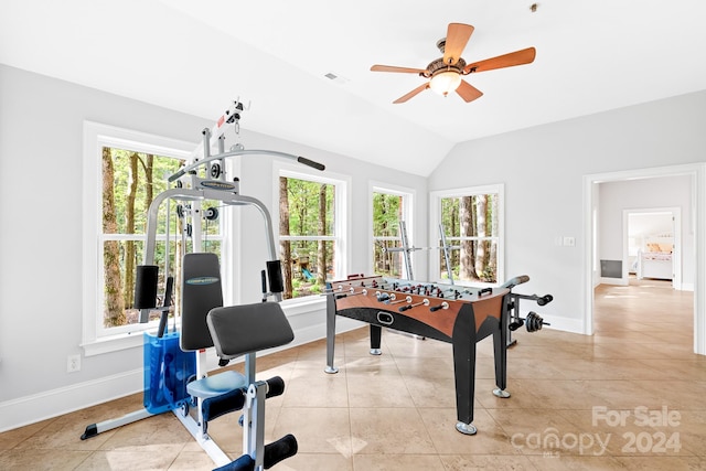 recreation room with lofted ceiling, ceiling fan, plenty of natural light, and light tile patterned floors