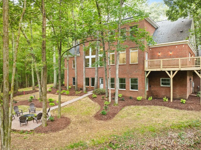 10250 Barringer Ct, Mount Pleasant, NC 28124 - rear view of property featuring an outdoor fire pit and brick siding