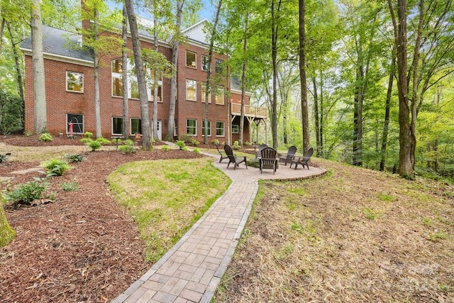 view of yard featuring a patio and a fire pit