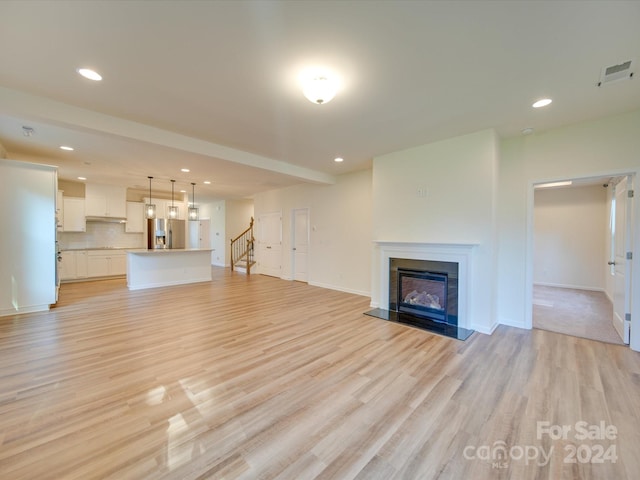 unfurnished living room featuring light hardwood / wood-style flooring