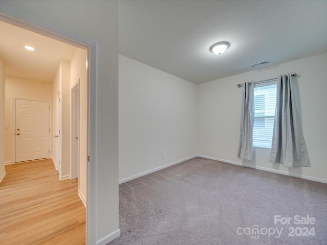 unfurnished room with light hardwood / wood-style flooring