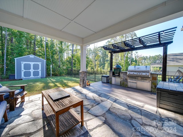 view of patio featuring a storage unit, area for grilling, an outdoor kitchen, and a pergola