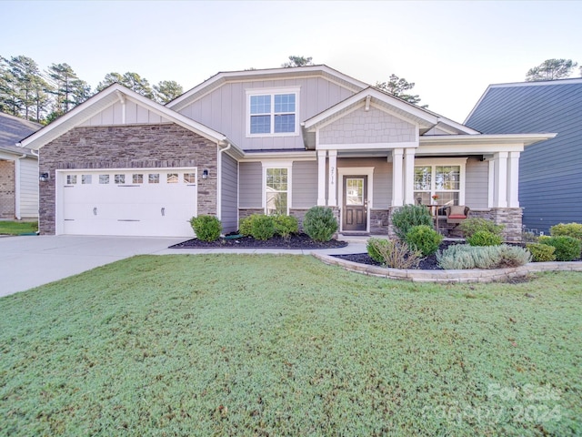 craftsman-style home with a front yard, a porch, and a garage