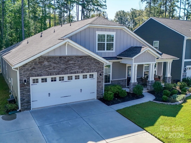 craftsman-style house featuring a front yard and a garage