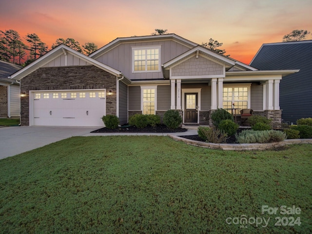 craftsman-style house featuring a yard and a garage