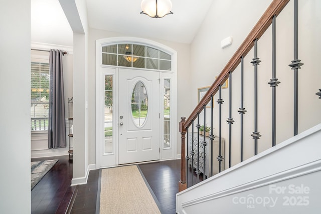 foyer entrance with lofted ceiling and dark hardwood / wood-style flooring