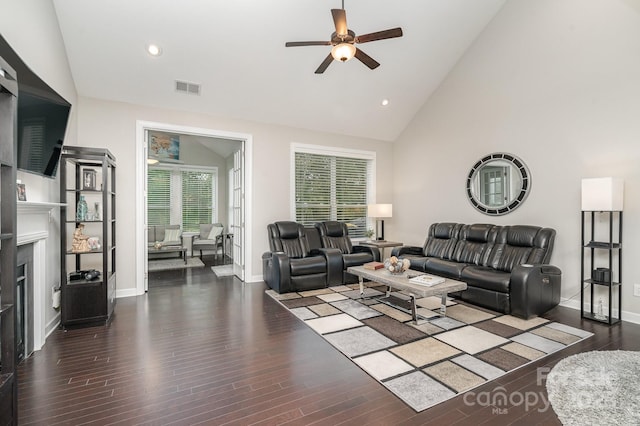 living room featuring dark hardwood / wood-style flooring, high vaulted ceiling, and ceiling fan