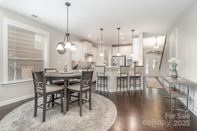 dining room with dark hardwood / wood-style floors