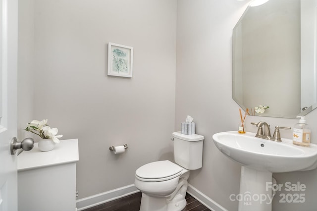 bathroom featuring hardwood / wood-style floors, sink, and toilet