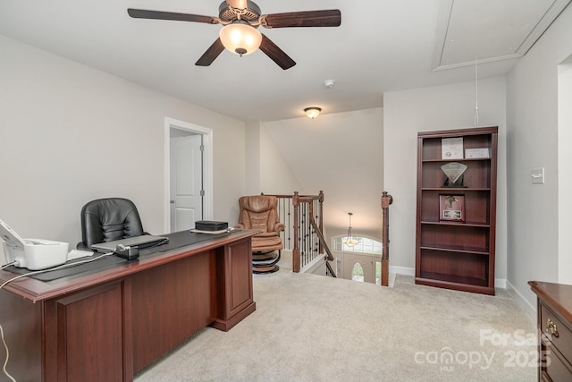 carpeted office space featuring ceiling fan