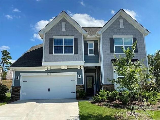 craftsman inspired home with a garage